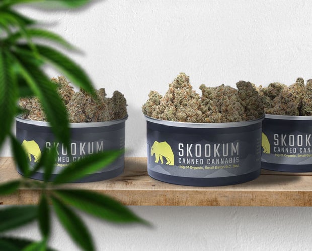 Skookum review featured photo. 3 skookum premium cannabis tins sit on a wooden board.