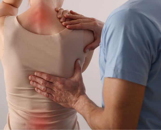 Woman with pain in the back and neck - relief
